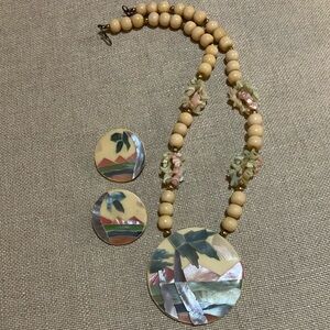 Vintage shell, mosaic, palm tree, mountains, and water.